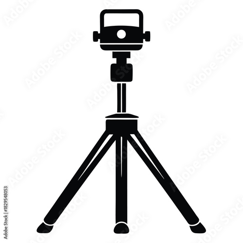 A solid black camera tripod stands ready to memories or cinematic scenes