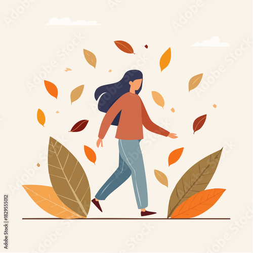 une femme se promenant sous les feuilles d’automne