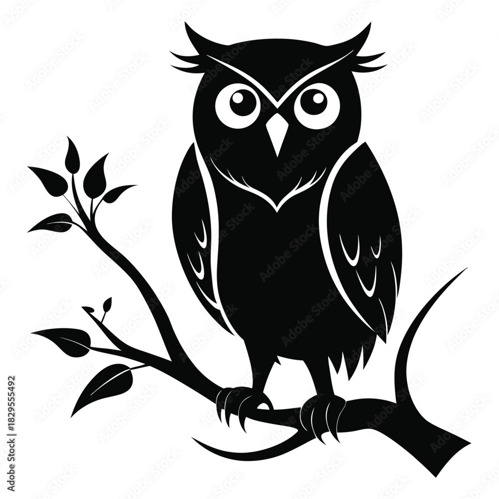 Fototapeta premium Black owl with pointed ears is perched on a leafy branch calmly