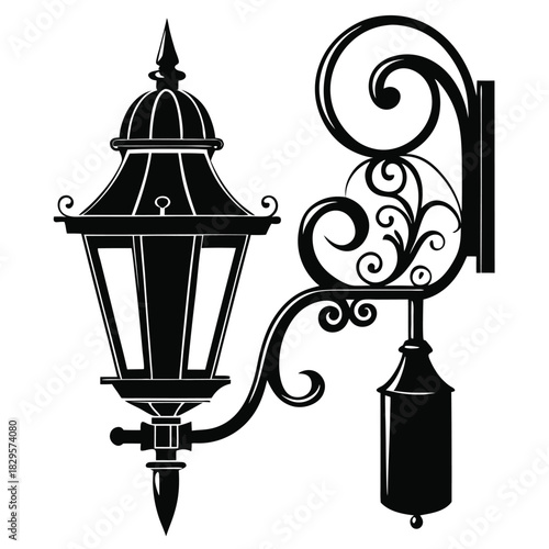 Detailed depicts a vintage black streetlight with ornate and swirling bracket