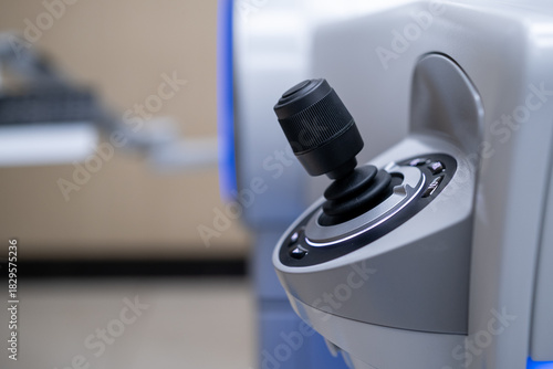 A close-up view of the ergonomic, high-precision joystick control interface used by the surgeon to manipulate and position the ZEISS Femtosecond Laser System during refractive eye surgery (SMI