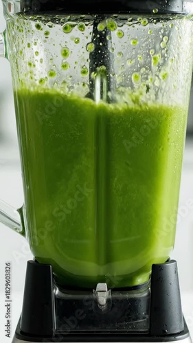 Healthy smoothie preparation with fresh fruits and vegetables in a blender at home kitchen