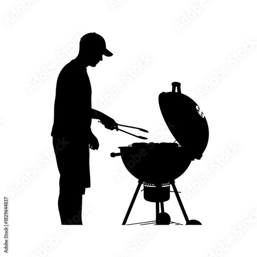 Silhouette of a man grilling on a barbecue, cooking with tongs, outdoor cooking concept
