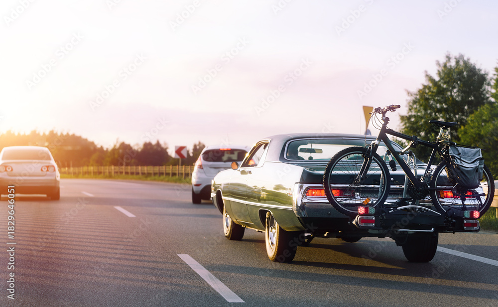 Fototapeta premium Classic vehicle with bicycle loaded for vacation