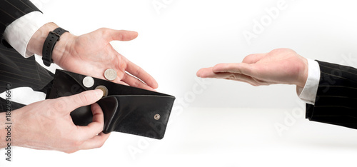 Financial difficulty shown by a person offering only a few coins from an almost empty wallet during a monetary exchange.