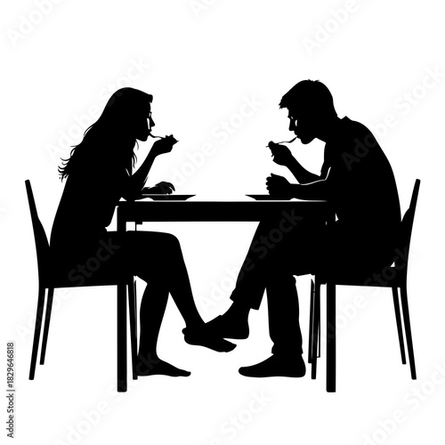 Silhouette of a man and woman sitting at a table eating and talking
