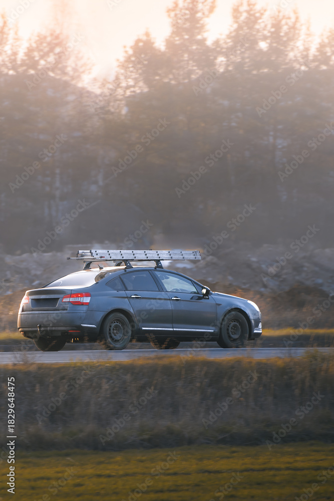 Naklejka premium Car with cargo box driving in nature landscape