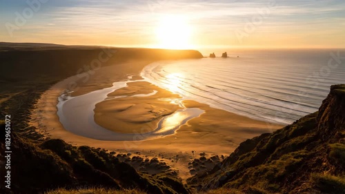 Coastal landscape at sunrise with headland and sandy beach