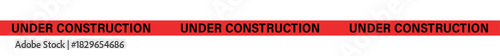 A red banner with the words under construction repeated three times on a white background in black letters , ribbons, stripes, tape
