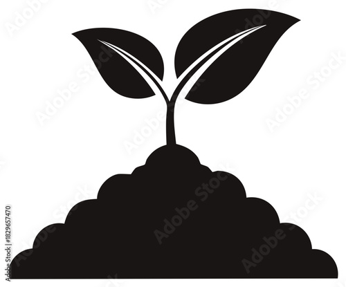 Green sprout growing from dark soil with two leaves symbolizing new life and growth