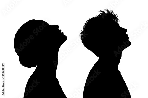 Silhouettes of two children looking upwards