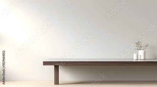 Serene modern living room interior with a dark wood and marble top bench or console table decorated with a minimalist white vase and dried botanical elements set against a soft