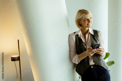 Woman smiling while using s...