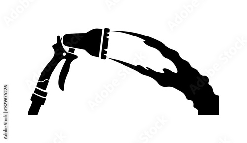 Watering hose spraying powerfully, perfect for gardening and outdoor cleaning tasks