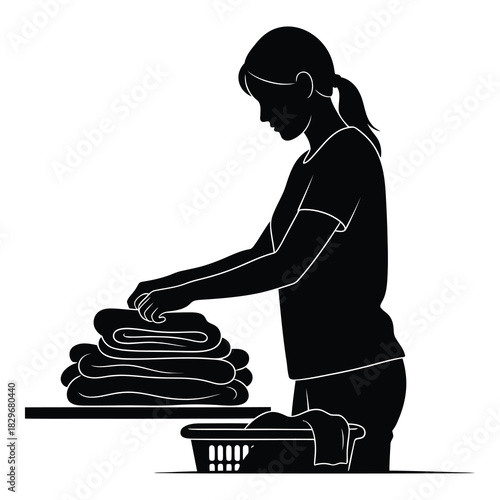 Silhouette of a woman folding laundry, isolated on white background she is standing at a table with a stack of folded towels and a laundry basket