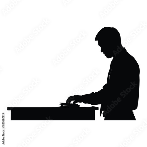 Silhouette of a man working at a desk isolated on white background, showcasing a focused individual in a professional setting, emphasizing simplicity and anonymity