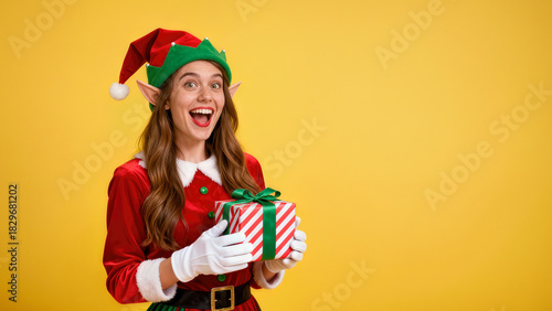 Happy holiday elf with a present, celebrating the festive season in a cheerful yellow backdrop, showcasing joy and anticipation for gift giving