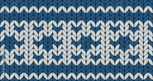 Cozy blue and white knitted pattern featuring geometric snowflake-like shapes for winter textiles and Scandinavian designs