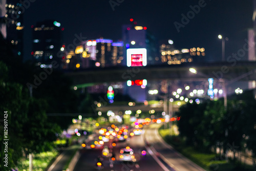 Defocused photo. Blurred of car in city at night, bokeh background. After edits.