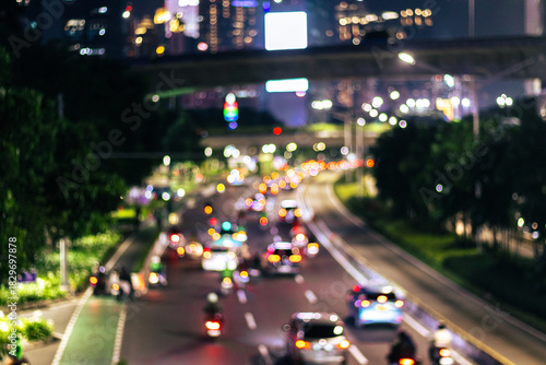 Defocused photo. Blurred of car in city at night, bokeh background. After edits.