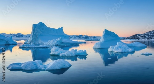 Scenic landscape of icebergs floating in the arctic waters at sunrise