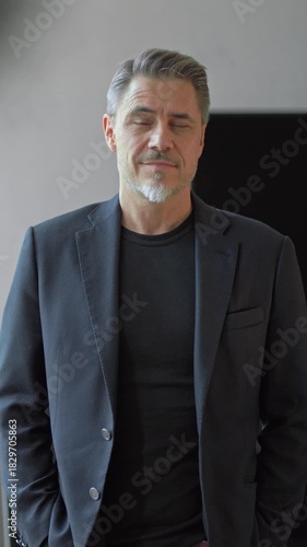 Portrait of confident businessman in business casual. Happy middle aged, mid adult, mature age man smiling. Entrepreneur in modern office.