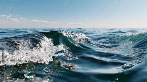 Fototapeta Naklejka Na Ścianę i Meble -  Close up of deep blue ocean wave cresting with white foam under a bright blue sky