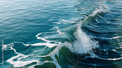 Fototapeta Naklejka Na Ścianę i Meble -  Detailed close up of a dynamic ocean wave cresting with white foam on deep blue water