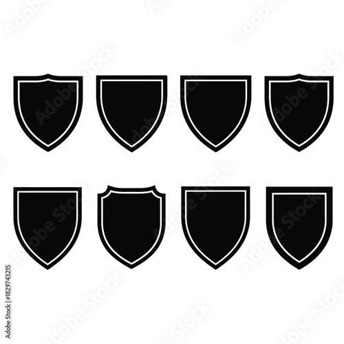 Collection of eight different black shield shapes with white borders, isolated on white background, representing security, protection, and heraldry concepts.