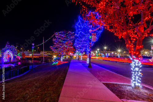 Beautifully illuminated urban street and Season Greetings from Caldwell banner. Caldwell, Idaho