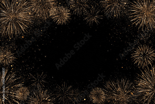 dazzling gold fireworks explode against a black night sky with scattered sparks