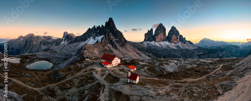 Scenic view of Tre Cime di Lavaredo peaks with Laghi dei Piani and Rifugio locatelli mountain hut in the sunset at Dolomites, italy