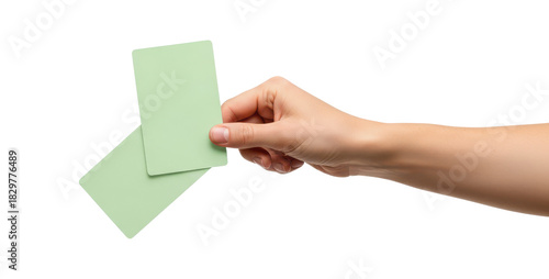 Female hand holding two blank light green vertical cards isolated on white.