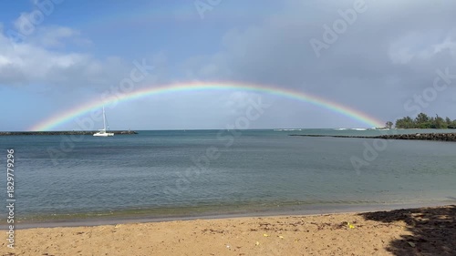 Rainbow over sailboat at Haleiwa Harbor on the Northshore of Oahu in the Hawaiian Islands. 