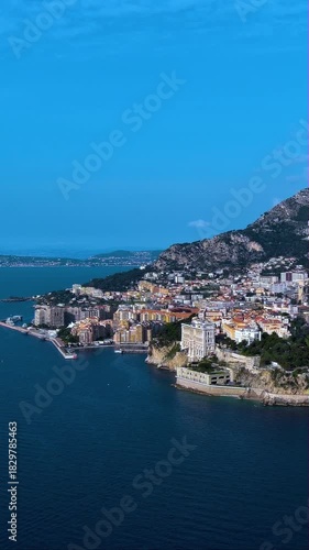 4K aerial vertical video of Monaco Oceanographic Museum on the cliff. Cinematic drone footage of Mediterranean coast and Fontvieille district. Iconic travel landmark for mobile reels.