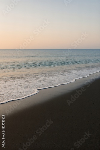 Gentle swell on twilight shoreline