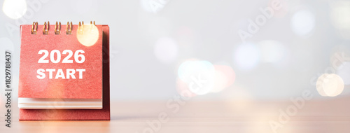 A desk calendar showing 2026 start with soft bokeh light representing the new year concept fresh beginnings annual planning motivation and inspiration for future goals and positive direction.