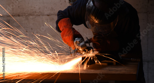 Close-up of angle grinder producing sparks while cutting metal