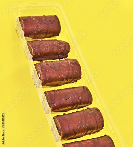 Mini Chocolate Cake Roll Swiss Roll on yellow background