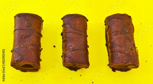 Mini Chocolate Cake Roll Swiss Roll on yellow background