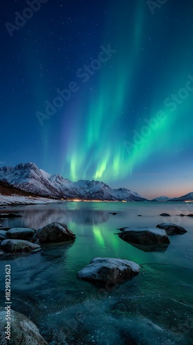 Breathtaking Northern Lights Display Over Snowy Norwegian Mountains and Frozen Shoreline