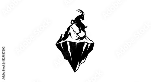 Silhouette of a Goat Standing Atop a Rocky Peak.