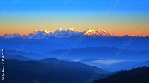 Fotografie Majestic snowy mountains dawn with a golden sunrise casting a warm glow over the