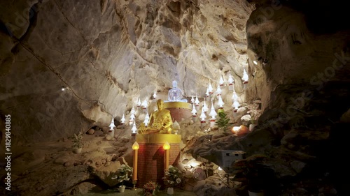 Khao Wong Cave, Khao Yai, Thailand - November 23, 2025: Statue of Luang Phor Sodh Candasaro, the famous Thai monk master, inside a cave temple. Golden monk sculpture for worship.
