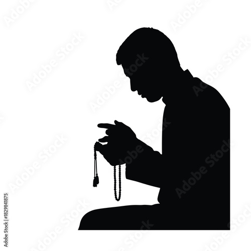 Man praying with prayer beads silhouette