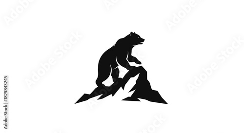 Black silhouette of a powerful bear climbing a rugged mountain peak.