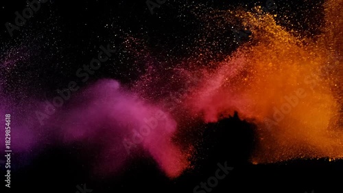 Vivid pink and orange dust cloud bursts in dramatic motion on black background, high-energy explosion, creative abstract concept