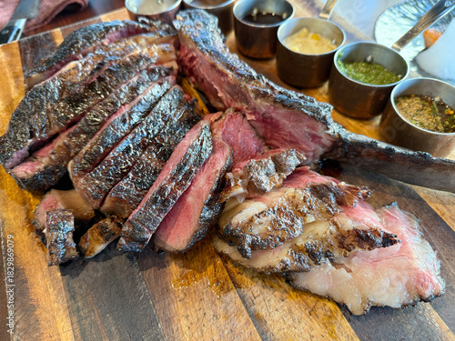 Tomahawk steak, the delicious grilled meat  dishes on the barbecue grill showcase a savory dinner meal