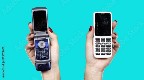 hand holding a sequence of old mobile phones 