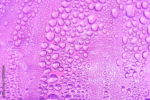 Abstract background featuring a macro view of water droplets on a violet surface, creating a natural pattern of moisture and condensation.